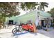 Green building with eclectic gift shop and outdoor seating at 210 Willow Ave, Anna Maria, FL 34216