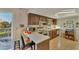 Galley kitchen with wood cabinets and breakfast bar at 210 Willow Ave, Anna Maria, FL 34216