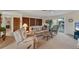 Living room with beige sofas, coffee table, and TV at 210 Willow Ave, Anna Maria, FL 34216