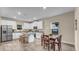 Modern kitchen with white cabinets, granite counters and island at 2106 Barrister St, North Port, FL 34288