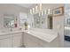 Bright bathroom boasts double sinks, tile counters, and a large vanity mirror at 2145 Pueblo Cir # V12, Sarasota, FL 34231