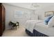 Bright bedroom with a queen bed, white dresser, and window shutters at 2145 Pueblo Cir # V12, Sarasota, FL 34231