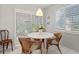 Bright dining area with white table and wicker chairs at 2145 Pueblo Cir # V12, Sarasota, FL 34231