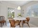 Charming breakfast nook with a white table and wicker chairs at 2145 Pueblo Cir # V12, Sarasota, FL 34231