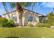 Front view of charming house with palm trees and manicured lawn at 2145 Pueblo Cir # V12, Sarasota, FL 34231