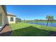 Backyard with pond view and lush grass at 221 Brindisi Cir, Nokomis, FL 34275