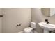 Small bathroom with white pedestal sink and toilet at 221 Brindisi Cir, Nokomis, FL 34275