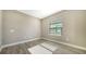 Simple bedroom with neutral walls and a window with blinds at 221 Brindisi Cir, Nokomis, FL 34275