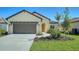 House exterior showcasing a two-car garage and well-manicured lawn at 221 Brindisi Cir, Nokomis, FL 34275