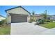 Two-car garage with a gray door and driveway at 221 Brindisi Cir, Nokomis, FL 34275