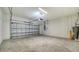 Spacious garage with overhead door and concrete floor at 221 Brindisi Cir, Nokomis, FL 34275