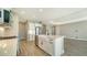 Modern kitchen featuring white cabinets, quartz countertops, and a farmhouse sink at 221 Brindisi Cir, Nokomis, FL 34275