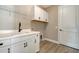 Laundry room with white cabinets and sink at 221 Brindisi Cir, Nokomis, FL 34275