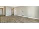 Spacious living room with wood-look tile flooring at 221 Brindisi Cir, Nokomis, FL 34275