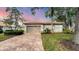 Well-maintained house with a brick driveway, and lush landscaping at 3339 Highlands Bridge Rd # 65, Sarasota, FL 34235