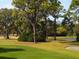 Golf course with lush green fairways, sand traps, and mature trees at 3339 Highlands Bridge Rd # 65, Sarasota, FL 34235