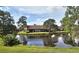 Community overview showcasing waterfront homes and lush greenery at 3354 Sandleheath # 13, Sarasota, FL 34235