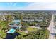 Aerial view of community pool, tennis courts, and building at 360 Pine Run Dr, Osprey, FL 34229