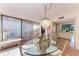 Sunlit dining room with glass table and access to a private patio at 360 Pine Run Dr, Osprey, FL 34229