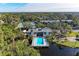 Community pool with lounge chairs and surrounding landscape at 360 Pine Run Dr, Osprey, FL 34229