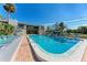 Community pool with lounge chairs and building in background at 360 Pine Run Dr, Osprey, FL 34229