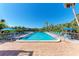 Community pool with lounge chairs and umbrellas at 360 Pine Run Dr, Osprey, FL 34229