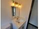 Modern bathroom with gold fixtures and white vanity at 3611 3Rd S Ave, St Petersburg, FL 33711