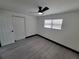 Spacious bedroom with ceiling fan and grey wood-look flooring at 3611 3Rd S Ave, St Petersburg, FL 33711