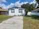 Newly renovated home with a paved driveway and well-manicured lawn at 3611 3Rd S Ave, St Petersburg, FL 33711