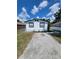 Newly renovated home with a paved driveway and well-manicured lawn at 3611 3Rd S Ave, St Petersburg, FL 33711