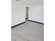 Bright hallway with grey wood-look flooring and black trim at 3611 3Rd S Ave, St Petersburg, FL 33711