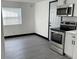 Bright kitchen with stainless steel appliances and grey vinyl flooring at 3611 3Rd S Ave, St Petersburg, FL 33711