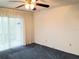 Spacious bedroom with blue carpet and sliding glass doors at 3756 Lake Bayshore # 509, Bradenton, FL 34205