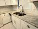 Modern kitchen sink and granite countertop at 3756 Lake Bayshore # 509, Bradenton, FL 34205