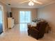 Spacious living room with sliding glass doors and tiled floors at 3756 Lake Bayshore # 509, Bradenton, FL 34205