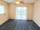 Spacious main bedroom with balcony access and carpet at 3756 Lake Bayshore # 509, Bradenton, FL 34205