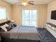 Main bedroom with balcony access and ceiling fan at 3756 Lake Bayshore # 509, Bradenton, FL 34205