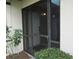 Front entrance with screen door and landscaping at 376 Oak Hill Dr # 36, Sarasota, FL 34232