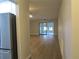 View of living room with wood-look floors and sliding glass doors at 376 Oak Hill Dr # 36, Sarasota, FL 34232