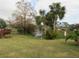 Landscaped view of pond with fountain and palm trees at 376 Oak Hill Dr # 36, Sarasota, FL 34232