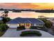 Luxury waterfront home with circular driveway, offering sunset views at 419 Yacht Harbor Dr, Osprey, FL 34229