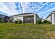 Home with screened porch, grassy yard, and manicured hedges at 4337 Sunmill Ct, Lakewood Ranch, FL 34211