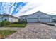 Two-story home with gray exterior, two-car garage and paver driveway at 4337 Sunmill Ct, Lakewood Ranch, FL 34211