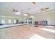 Large fitness studio with hardwood floors, mirrors, and ceiling fans at 4337 Sunmill Ct, Lakewood Ranch, FL 34211