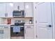 Stainless steel appliances and white shaker cabinets in this well-lit kitchen at 4337 Sunmill Ct, Lakewood Ranch, FL 34211