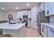 Modern kitchen with white cabinets, stainless steel appliances and a large island at 4337 Sunmill Ct, Lakewood Ranch, FL 34211