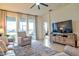 Bright living room with large windows, comfortable seating and a view of the lake at 4337 Sunmill Ct, Lakewood Ranch, FL 34211