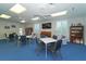 Community room with tables, chairs, bookshelves, and a TV at 4424 Mount Vernon Dr, Bradenton, FL 34210