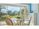 Dining area with glass table and wicker chairs, overlooking backyard at 4424 Mount Vernon Dr, Bradenton, FL 34210