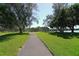 Scenic walking path winds through lush green landscape towards waterfront at 4424 Mount Vernon Dr, Bradenton, FL 34210